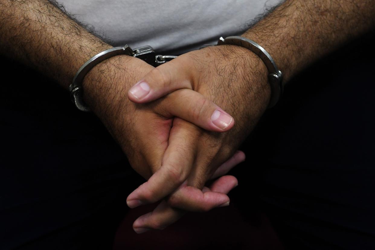 A man in handcuffs. PHOTO: MARVIN RECINOS/AFP/Getty Images
