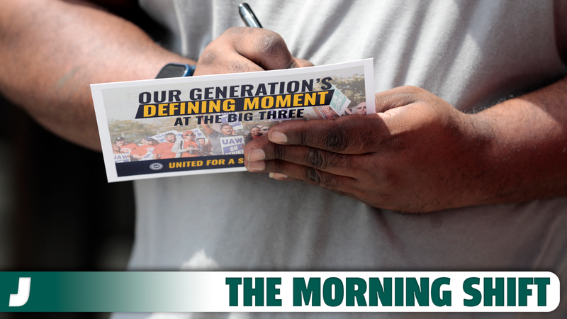 UAW workers sign UAW pledge cards as they leave their shift at General Motors Factory Zero in Detroit, Michigan, on July 12, 2023.