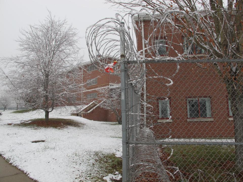 Razor wire surrounds the former Bergin Correctional Institution in Mansfield, Conn., Wednesday, Nov. 27, 2012. A year after the last inmate left the prison, the University of Connecticut is in talks with the state to lease the building as it seeks out more space for offices and laboratories. (AP Photo/Pat Eaton-Robb)