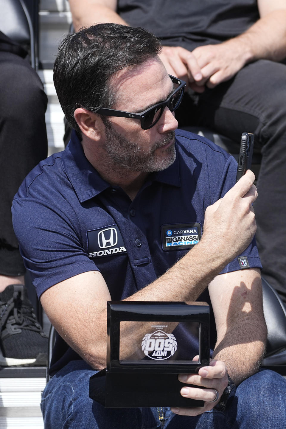 Jimmie Johnson takes a photo during the drivers meeting for the Indianapolis 500 auto race at Indianapolis Motor Speedway, Saturday, May 28, 2022, in Indianapolis. (AP Photo/Darron Cummings)