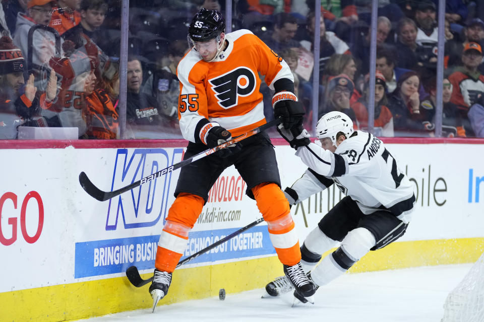 Philadelphia Flyers' Rasmus Ristolainen, left, and Los Angeles Kings' Jaret Anderson-Dolan battle for the puck during the third period of an NHL hockey game, Tuesday, Jan. 24, 2023, in Philadelphia. (AP Photo/Matt Slocum)