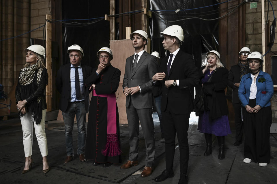 Canadian Prime Minister Justin Trudeau, fourth left, French Culture Minister Franck Riester, fourth right, Notre Dame cathedral rector Patrick Chauvet, third left, and French chief architect of Historical Sites Philippe Villeneuve, second left, visit the Notre Dame de Paris cathedral, Wednesday May 15, 2019 in Paris. (Philippe Lopez/Pool via AP)