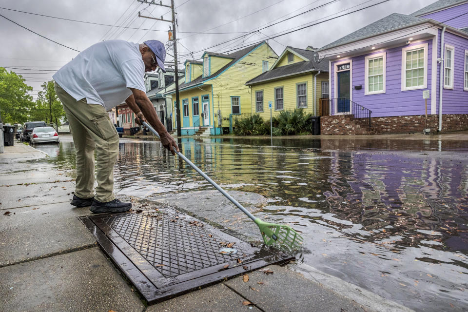Russell Stones cleans out a drain in the Treme neighborhood in New Orleans on Wednesday, April 10, 2024. Severe thunderstorms were expected across parts of the Louisiana, Mississippi, Alabama and the Florida panhandle and there was the potential for tornadoes, a few of which may be strong, and damaging winds, which may exceed 75 mph (120 kph), the National Weather Service warned.(Photo by Chris Granger/The Times-Picayune/The New Orleans Advocate via AP)