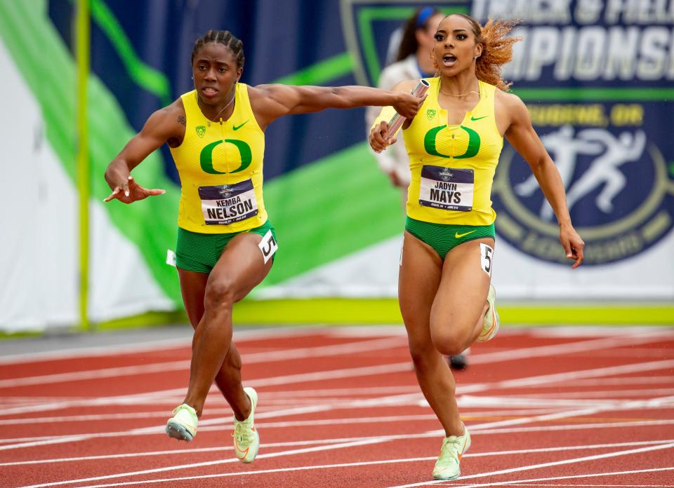 Oregon’s Jadyn Mays passes the baton to teammate Kemba Nelson in the women’s 4x100 meter relay on the fourth day of the NCAA outdoor track & field championships Saturday, June 11, 2022 at Hayward Field in Eugene, Ore.