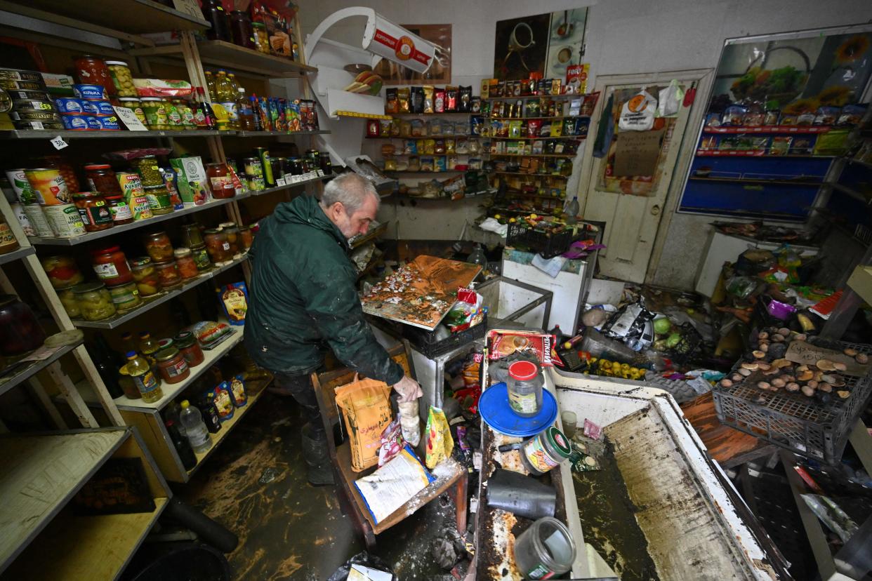 Oleksiy, 60, cleans his grocery store damaged by flooding, in the town of Kherson (AFP via Getty Images)