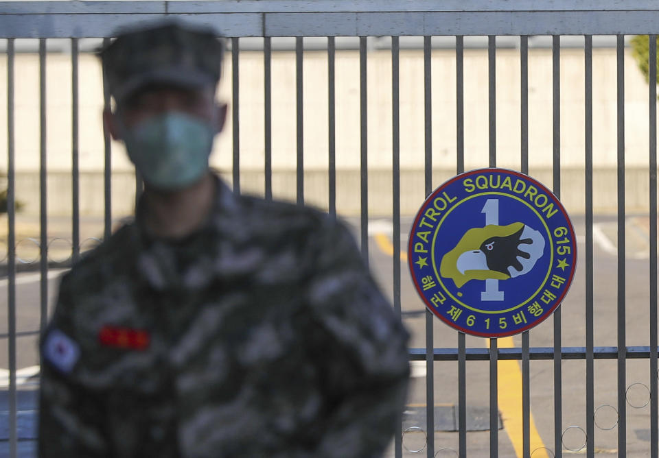 A South Korean marine wearing a mask stands in front of the Navy Base on Feb. 21, 2020, after a soldier of the unit was confirmed to have been infected with the coronavirus on Jeju Island, South Korea.(Woo Jang-ho/Yonhap via AP)                                        