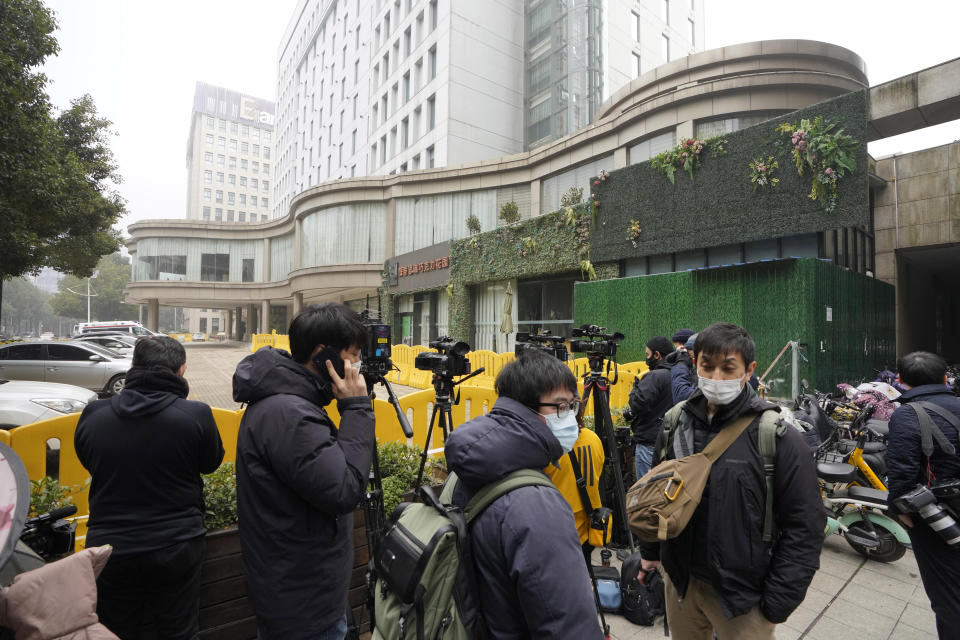 Journalists gather outside the hotel where a team of experts from the World Health Organization are quarantined in Wuhan in centra China's Hubei province on Thursday, Jan. 28, 2021. A World Health Organization team has emerged from quarantine in the Chinese city of Wuhan to start field work in a fact-finding mission on the origins of the virus that caused the COVID-19 pandemic.(AP Photo/Ng Han Guan)