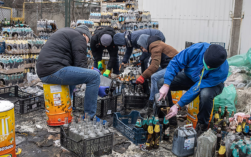 Ukrainians prepare Molotov cocktails outside their homes in Lviv, Ukraine, on March 2. Russian troops entered Ukraine on Feb. 24, triggering a Ukrainian resistance and a series of announcements by Western countries to impose severe economic sanctions on Russia. <em>Oleksandr Khomenko/UPI Photo</em>