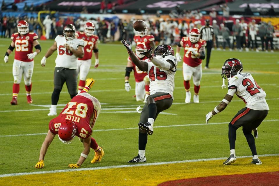 Tampa Bay linebacker Devin White intercepts a pass intended for Kansas City tight end Travis Kelce.