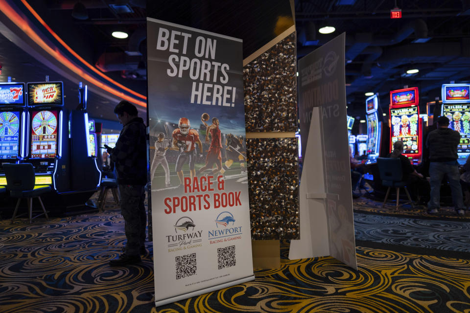 A sign promoting sports betting is on display near a side entrance and among other electronic gaming machines at Turfway Park Racing & Gaming, Friday, Dec. 22, 2023, in Florence, Ky. Sports betting has spread rapidly across U.S. states in the past five years. But the odds for further expansion may be fading as state legislatures prepare to return to work in 2024. (AP Photo/Carolyn Kaster)