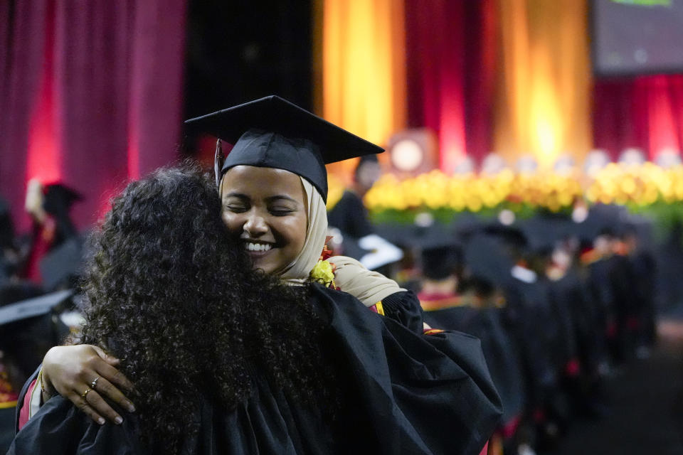 Asna Tabassum hugs a fellow graduate during commencement for the University of Southern California's Viterbi School of Engineering Friday, May 10, 2024, in Los Angeles. (AP Photo/Ryan Sun)