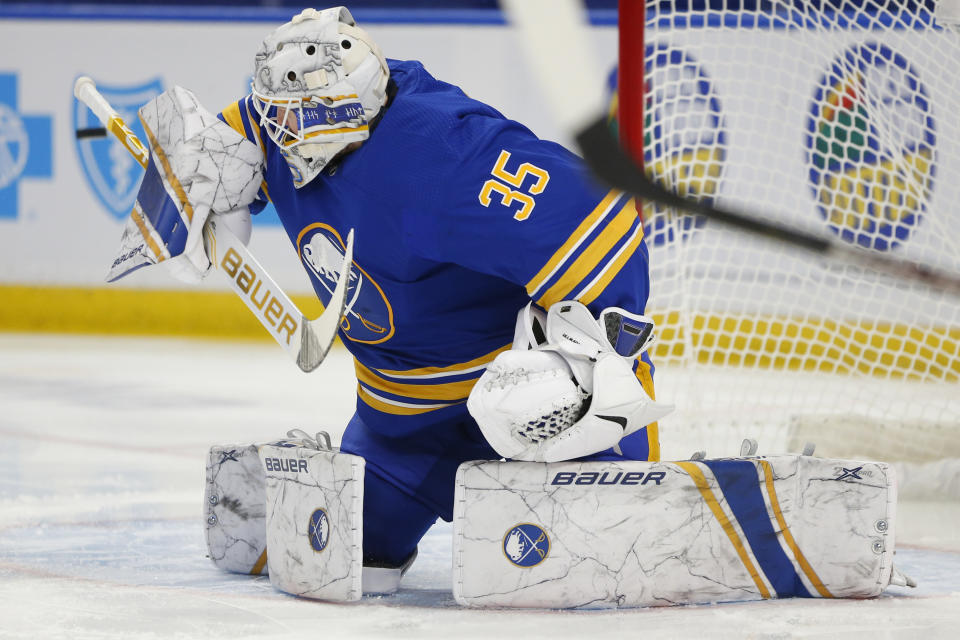 Buffalo Sabres goalie Linus Ullmark (35) makes a save during the first period of an NHL hockey game against the New York Islanders, Monday, Feb. 15, 2021, in Buffalo, N.Y. (AP Photo/Jeffrey T. Barnes)