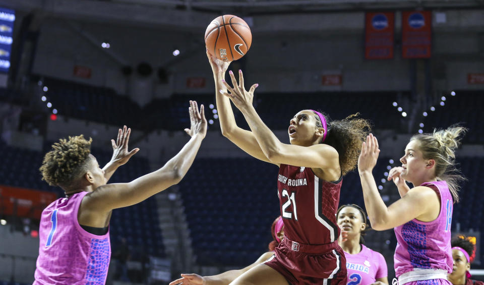 South Carolina forward Mikiah Herbert Harrigan (21) shoots over Florida guard Kiara Smith (1) while defended by Kristina Moore (14), right, during the first half of an NCAA college basketball game Thursday, Feb. 27, 2020, in Gainesville, Fla. (AP Photo/Gary McCullough)