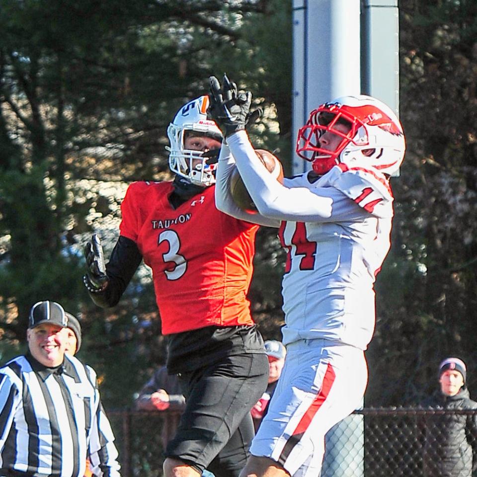 Milford’s CJ Farrell intercepts a pass intended for Taunton’s Jose Touron during Thursday’s Thanksgiving Day game.