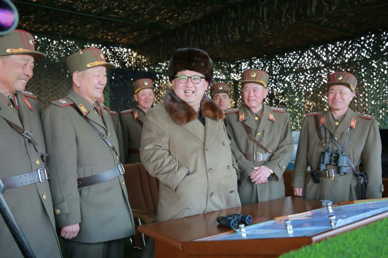 Picture released by North Korea's official Korean Central News Agency shows North Korean leader Kim Jong-Un (C) inspecting an artillery drill at an undisclosed location