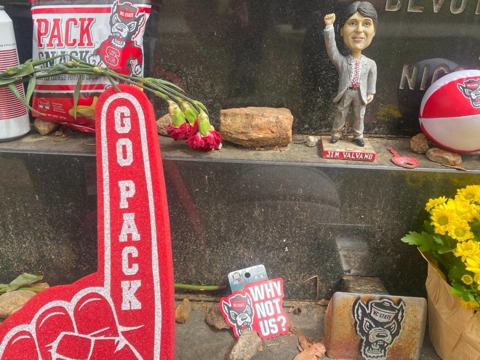 NC State fans deliver fresh gifts to Jim Valvano’s grave in Oakwood Cemetery.