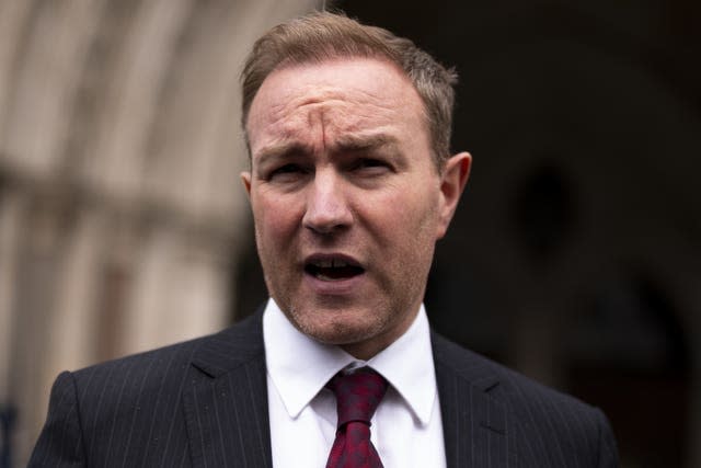 Tom Hayes in dark suit and maroon tie head and shoulders