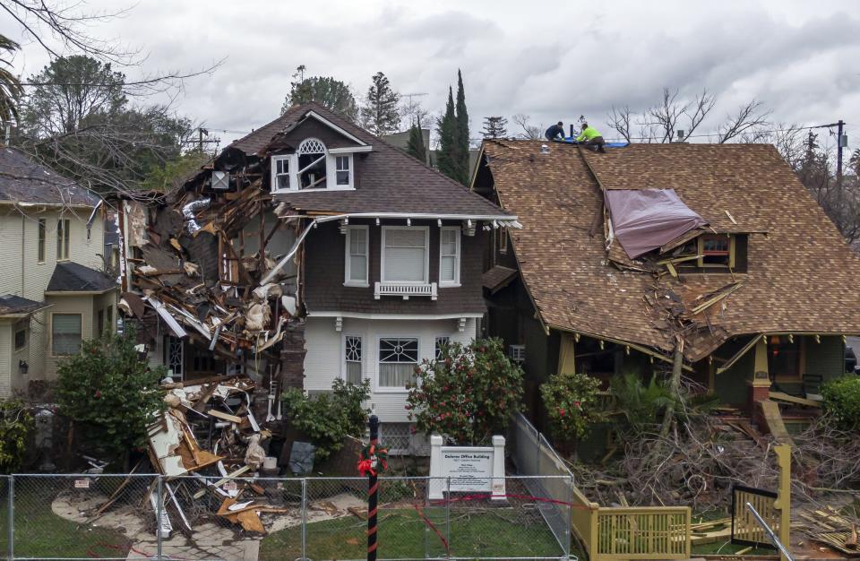 Extensive damage to homes and businesses on Capitol Avenue in Sacramento, Calif., is seen Tuesday, Jan. 10, 2023, following a storm Saturday night that downed trees and power lines throughout the region. (Xavier Mascareñas/The Sacramento Bee via AP)