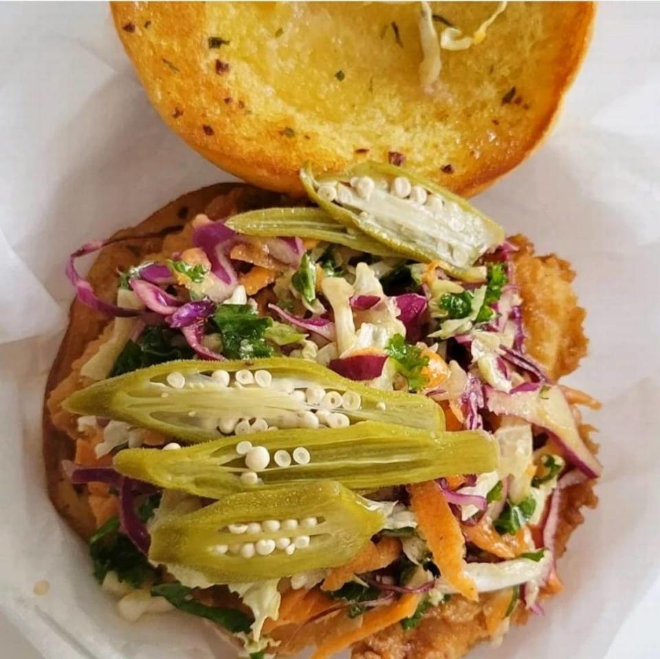 Bradentrucky Grub Truck’s Buttermilk Fried Chicken Sandwich uncovered, showing the lychee slaw and pickled okra.