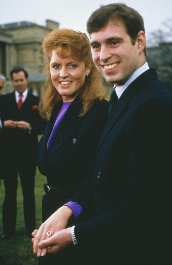 Prince Andrew with Sarah Ferguson at Buckingham Palace after the announcement of their engagement, London, 17th March 1986. Ferguson's white and yellow gold engagement ring features a Burma ruby, surrounded by ten drop-diamonds. (Getty Images)