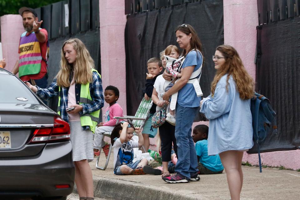 A family of anti-abortion activists stand outside "The Pink House" as the Jackson Women's Health Organization clinic was sometimes called, as they call on patients being dropped off at the facility to hold off having an abortion, while a clinic escort, signals the driver into their parking lot on Wednesday, March 25, 2020, in Jackson. The clinic was Mississippi's only state licensed abortion facility.