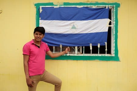 Carlos Quintero a migrant from Nicaragua, who was sent back to Mexico from the U.S. under Migrant Protection Protocols (MPP) stands next to Nicaraguan flag at the Pan de Vida migrant shelter at Anapra neighbourhood, in Ciudad Juarez