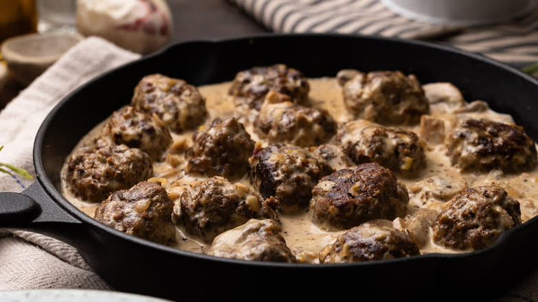 Venison meatballs with mushroom gravy in pan