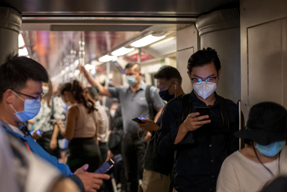 Commuters wear face masks to protect themselves from air pollution and new virus in Bangkok, Thailand, Wednesday, Feb. 5, 2020. Thailand confirmed six more cases of a new virus Tuesday, raising its total to 25. (AP Photo/Gemunu Amarasinghe)