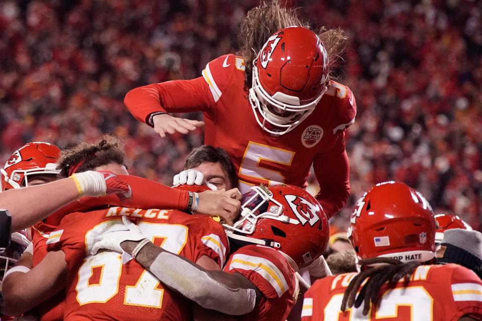 Kansas City Chiefs tight end Travis Kelce (87) celebrates with teammates after catching an 8-yard touchdown pass during overtime in an NFL divisional round playoff football game against the Buffalo Bills, Sunday, Jan. 23, 2022, in Kansas City, Mo.