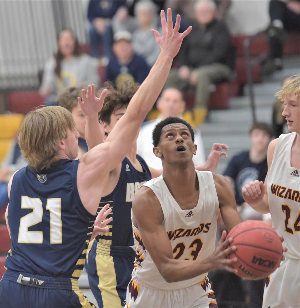 Windsor High School boys basketball player David Hageman eyes the basket after driving past two Palmer Ridge defenders during a Class 4A playoff game Saturday in Windsor.