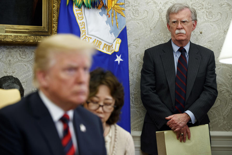 In this May 22, 2018, file photo, U.S. President Donald Trump, left, meets with South Korean President Moon Jae-In in the Oval Office of the White House in Washington, as national security adviser John Bolton, right, watches. Trump says he fired national security adviser John Bolton, says they 'disagreed strongly' on many issues. (AP Photo/Evan Vucci, File)