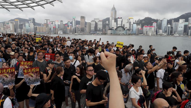 Protesters march near the skyline of Hong Kong, in this July 7, 2019, file photo. Utah Rep. John Curtis is one of five U.S. lawmakers named in a petition filed to Hong Kong’s High Court that would enable Hong Kong citizens and law enforcement to arrest the members of Congress in the city.