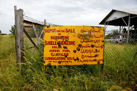 Bullet holes are seen in an abandoned fuel depot sign in the town of Malakal, in the Upper Nile state of South Sudan, September 8, 2018. REUTERS/Baz Ratner