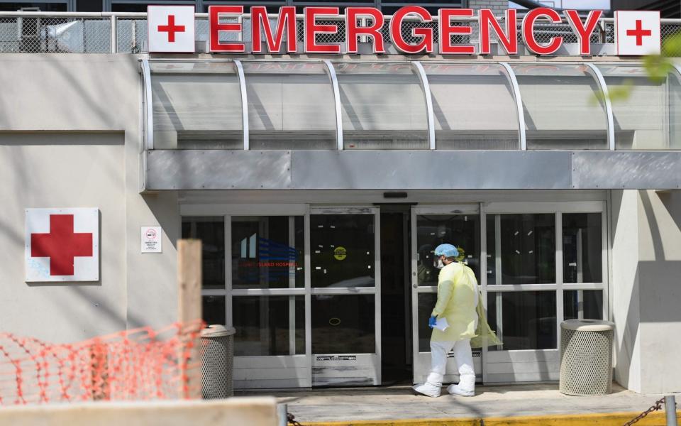 A Medical worker enters the emergency room at a hospital in the Brooklyn borough of New York City - AFP