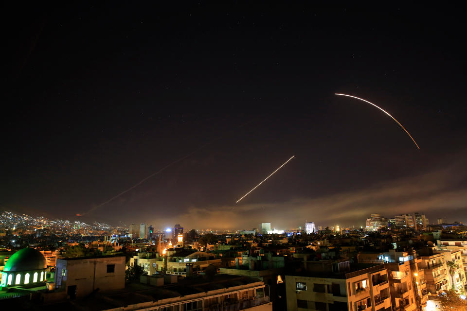 <em>Missiles streak across the Damascus skyline during the air strikes (AP)</em>