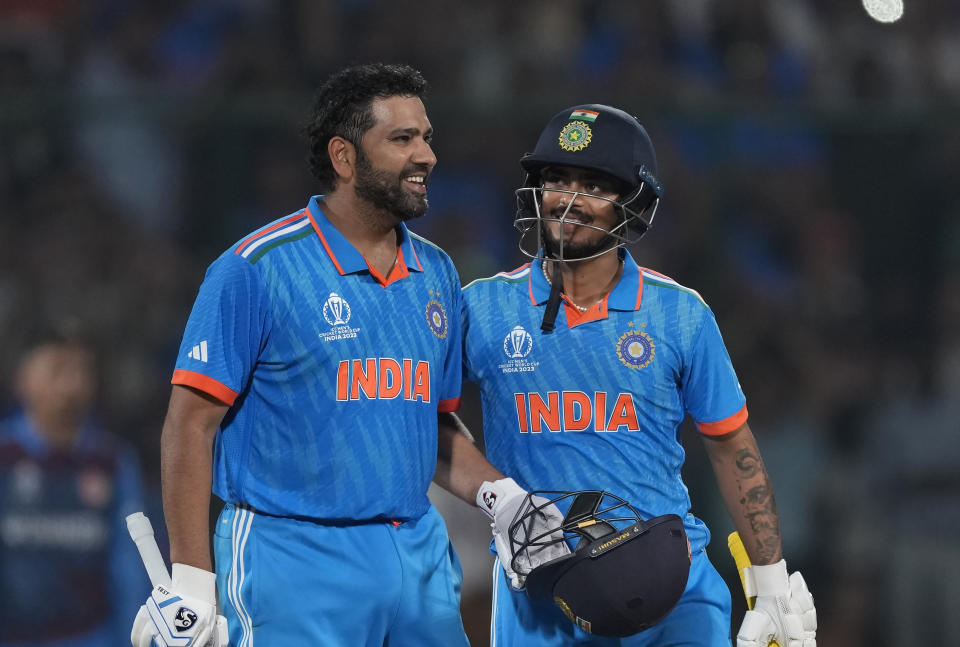 India's captain Rohit Sharma celebrates his century with teammate Ishan Kishan during the ICC Men's Cricket World Cup match between Afghanistan and India in New Delhi, India, Wednesday, Oct. 11, 2023. (AP Photo/Manish Swarup)