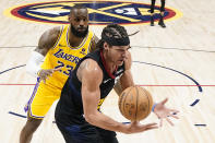 Denver Nuggets forward Aaron Gordon (50) grabs a loose ball against Los Angeles Lakers forward LeBron James (23) during the second half in Game 2 of an NBA basketball first-round playoff series, Monday, April 22, 2024, in Denver. (AP Photo/Jack Dempsey)