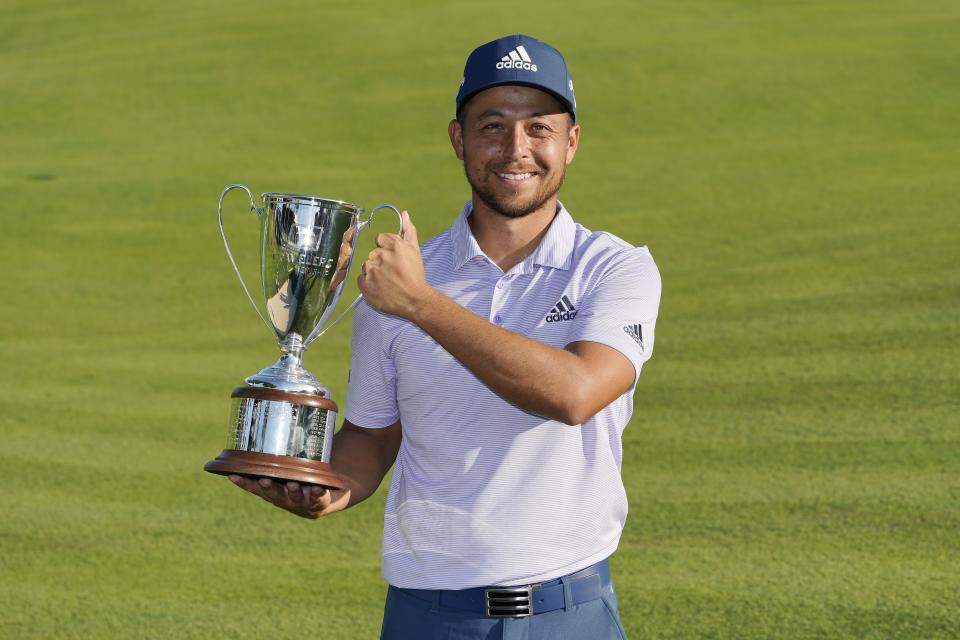 Xander Schauffele holds the trophy after winning the Travelers Championship golf tournament at TPC River Highlands, Sunday, June 26, 2022, in Cromwell, Conn. (AP Photo/Seth Wenig)