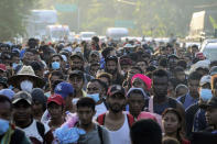 A caravan of migrants, mostly from Central America, head north along coastal highway just outside of Huehuetan at Chiapas State, Mexico, on Sunday, October 24, 2021. (AP Photo / Marco Ugarte)