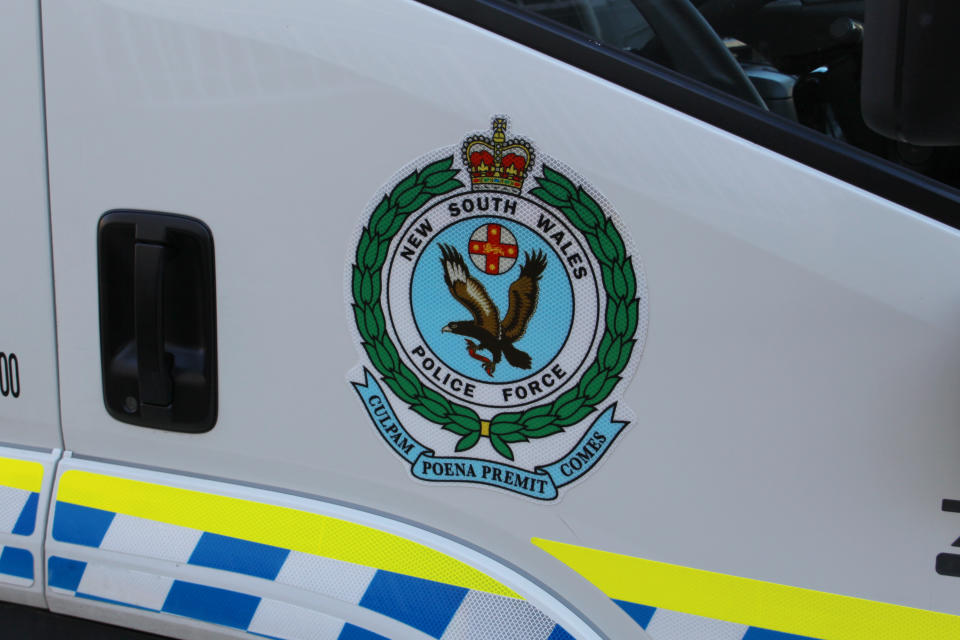 A stock image of a NSW Police Force logo on a vehicle.