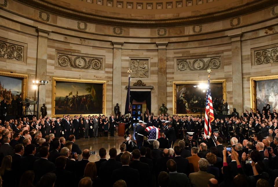 11) The crowd watches as the military honor guard places the casket in the Rotunda.