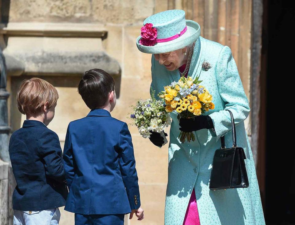 <p>Queen Elizabeth, who wore a pink and teal ensemble, was delighted by two young boys who presented her with flowers.</p>
