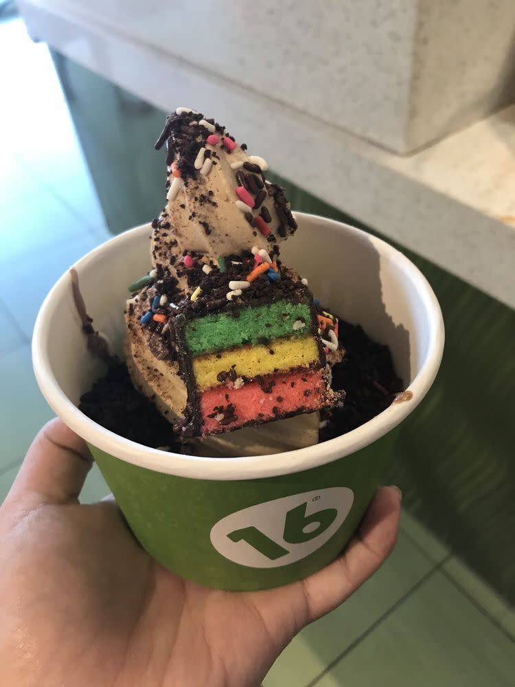 Cup of frozen yogurt with a piece of rainbow cake from 16 Handles