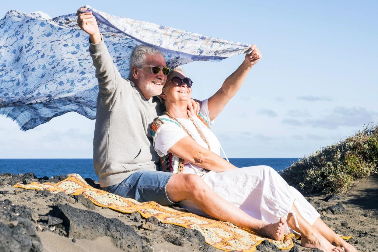 senior couple on beach smiling