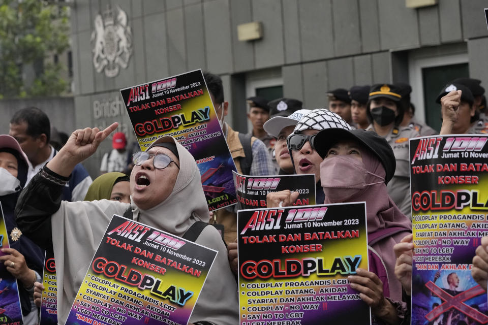 Muslims shout slogans during a rally against British band Coldplay outside the British embassy in Jakarta, Indonesia, Friday, Nov. 10, 2023. Dozens of conservative Muslims marched in Indonesia's capital on Friday calling for cancellation of Coldplay's concert later this month, saying the British band's support of lesbian, gay, bisexual, and transgender will corrupt young people. (AP Photo/Achmad Ibrahim)