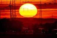 The sun rises above a highway in Frankfurt, Germany, Tuesday, Aug. 2, 2022. (AP Photo/Michael Probst)