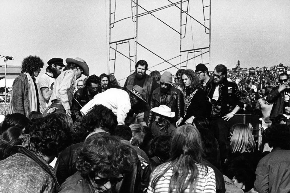 Marty Balin of Jefferson Airplane (on the ground in the white hat) is surrounded Hells Angels at the Altamont Speedway on Dec. 6, 1969 in Livermore, Calif. (Photo: Robert Altman/Michael Ochs Archives/Getty Images)