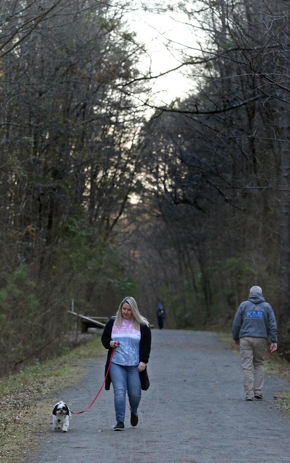 Rebecca Wells and “Jax”  walk along the Rail Trail Loop Tuesday afternoon, Jan. 25, 2022, at the Gateway Trail in Kings Mountain.