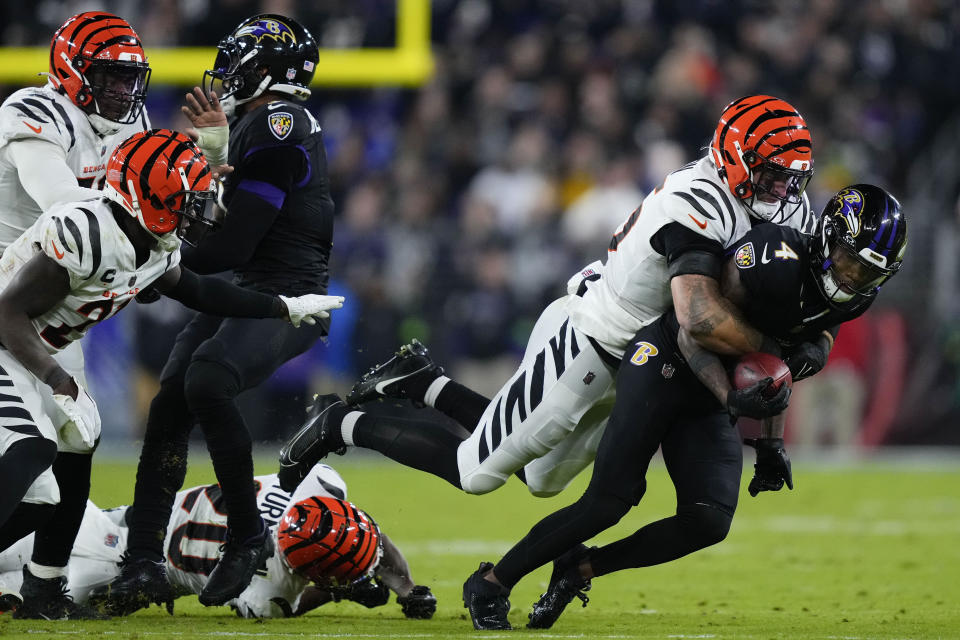 Cincinnati Bengals linebacker Logan Wilson (55) tackles Baltimore Ravens wide receiver Zay Flowers (4) in the second half of an NFL football game in Baltimore, Thursday, Nov. 16, 2023. (AP Photo/Matt Rourke)