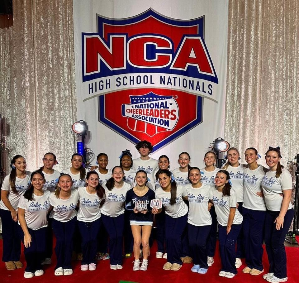 The John Jay cheerleading team poses while celebrating after winning the Go Be Great award, presented by the the National Cheerleaders Association in recognition of community service, on Jan. 19, 2023.